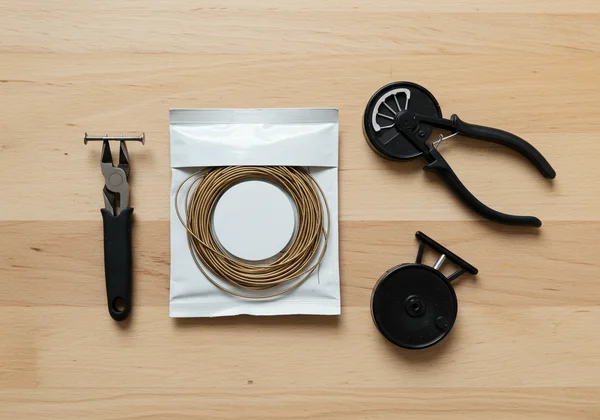 Essential tools for changing guitar strings laid out.